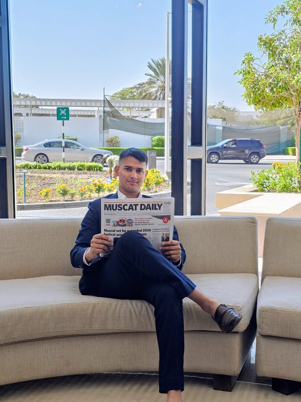 Asmod Khakurel reading the Muscat Daily in Oman